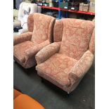 A pair of wing back armchairs