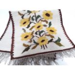 A wool runner decorated in sun flowers.