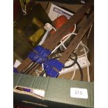 A box of misc including sash clamps, hedge trimmer, gang plug, etc.