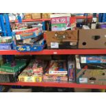 A large quantity of vintage board games - top and middle shelves.