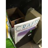A box of crafts books and a box of jigsaws.