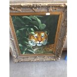 A modern oil on canvas, a tiger in the undergrowth, monnogrammed 'LWH', in ornate reproduction