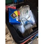 A crate containing house phone, mobile phone etc