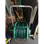 A garden hose reel on wheels.