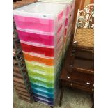 Two plastic multi drawer, multi coloured storage drawers.