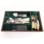 A cutlery tray with various plated cutlery and a set of 16 modernist style stainless steel spoons.