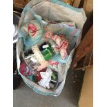 A bag of sewing items and accessories and material