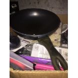 A box of mixed items including wok, phone chargers, etc.