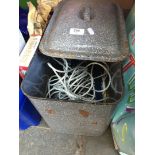 Enameled metal bread bin containing various tools.