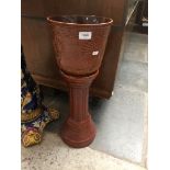 A brown glazed jardiniere on stand