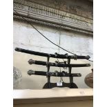 Set of Samurai style swords on display stand