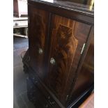 A reproduction mahogany cabinet