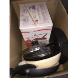 A box of kitchenware to include frying pans, mincer, etc.