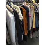 Large quantity of clothing to include trench coat, jackets, cardigans, blouses, etc.