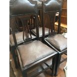 A set of 4 oak chairs with studded leather