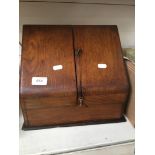 An antique oak stationery cabinet and contents