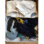 A box of lace tableware ans a box of feathers