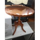 A small glass top yew wood table