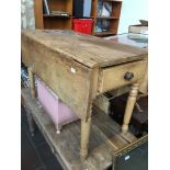 A 19th century drop leaf table with single drawer