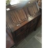 An oak linen fold bureau