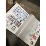 A stamp album containing a large quantity of stamps