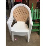 A set of 4 white plastic chairs