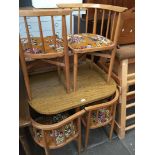 A vintage wood effect kitchen table and four corner chairs with original floral upholstery
