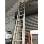 A set of aluminium extending ladders.