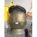 A large brass coal bucket.