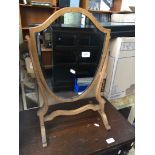 A shield shaped swing mirror