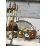 A collection of metalware including brass companion set, brass jugs, copper pan and plated tray