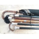 A mixed lot of antique walking canes including two with hallmarked silver tops, four others with