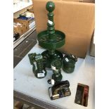 A quantity of green cast metal vintage kitchen items including a stand, pepper grinder, garlic