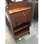 An early 20th century oak bureau with copper bound hinges