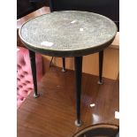 An eastern brass round side table with spindle legs