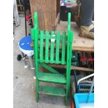 A small set of green painted wooden stepladders