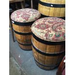 A pair of metal bound barrels with upholstered tops