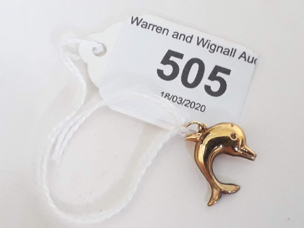 A hallmarked 9ct gold dolphin charm.