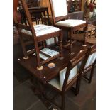 A Wood Bros. Old Charm oak drawer leaf dining table and 6 chairs.