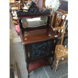 A mahogany cabinet with mirror back