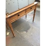 A 19th century pine two drawer side table
