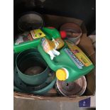 A box of plastic and stoneware planters and garden chemicals.