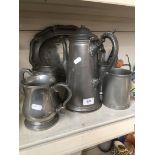 A mixed lot pf pewter comprising four tankards, an oval dish and a chocolate pot.