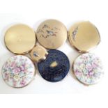 A group of eight vintage compacts.