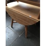 An Ercol pine drop leaf table.