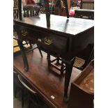 A 19th century table with single drawer and brass swan neck handles