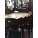 A mahogany extending dining table and three splat back chairs