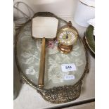 A dressing table tary, mirror and a small brass clock