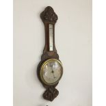 An oak cased barometer - J.J. Lockwood, Preston.