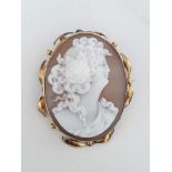 A Victorian shell cameo brooch in fancy mount marked '9ct'.